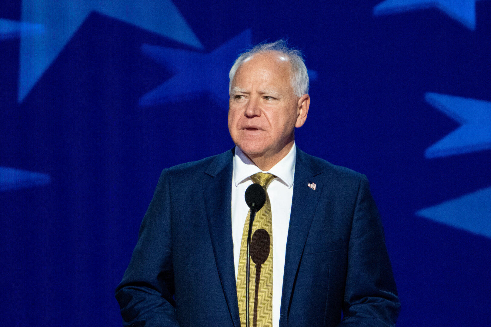 Minnesota Gov. and vice presidential nominee Tim Walz does a podium check Wednesday before the Democratic National Convention resumes in Chicago. (Bill Clark/CQ Roll Call)