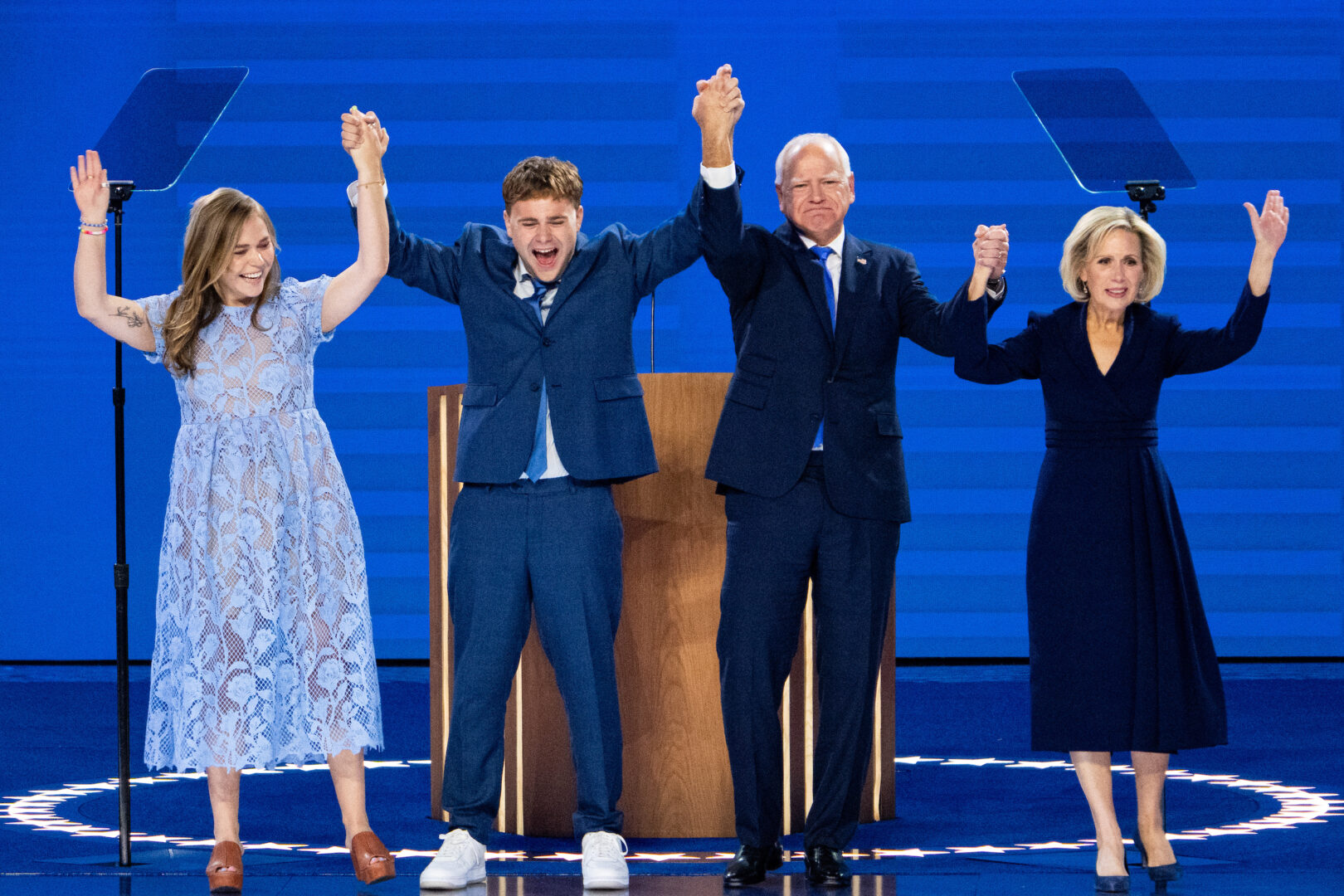 Tim Walz, governor of Minnesota and Democratic vice-presidential nominee, is pictured on the United Center stage in Chicago on Wednesday  after addressing the convention crowd. With him are, from left, his daughter Hope, son Gus and wife Gwen.