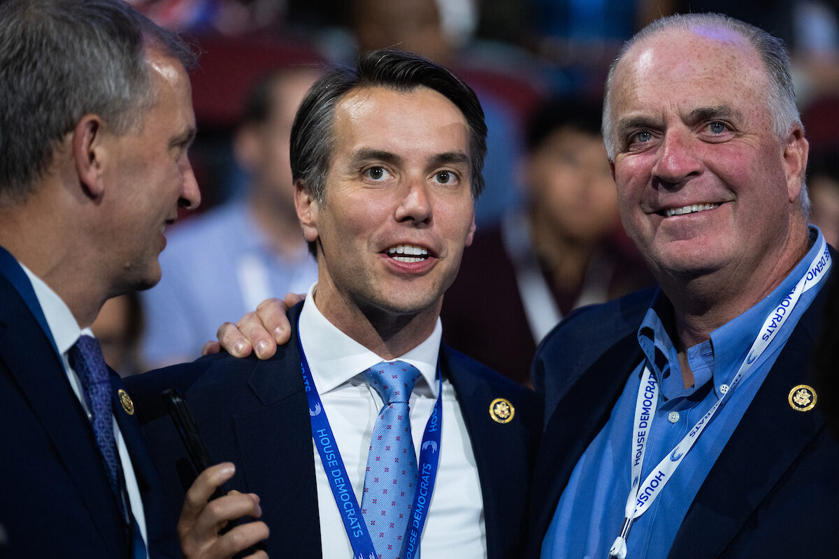 From left, Reps. Sean Casten, D-Ill., Morgan McGarvey, D-Ky., and Dan Kildee, D-Mich., are seen on the first night of the Democratic National Convention at the United Center in Chicago on Aug. 19. McGarvey is among the members scheduled to perform at the Congressional Record 2024 music event on Sept. 17. 