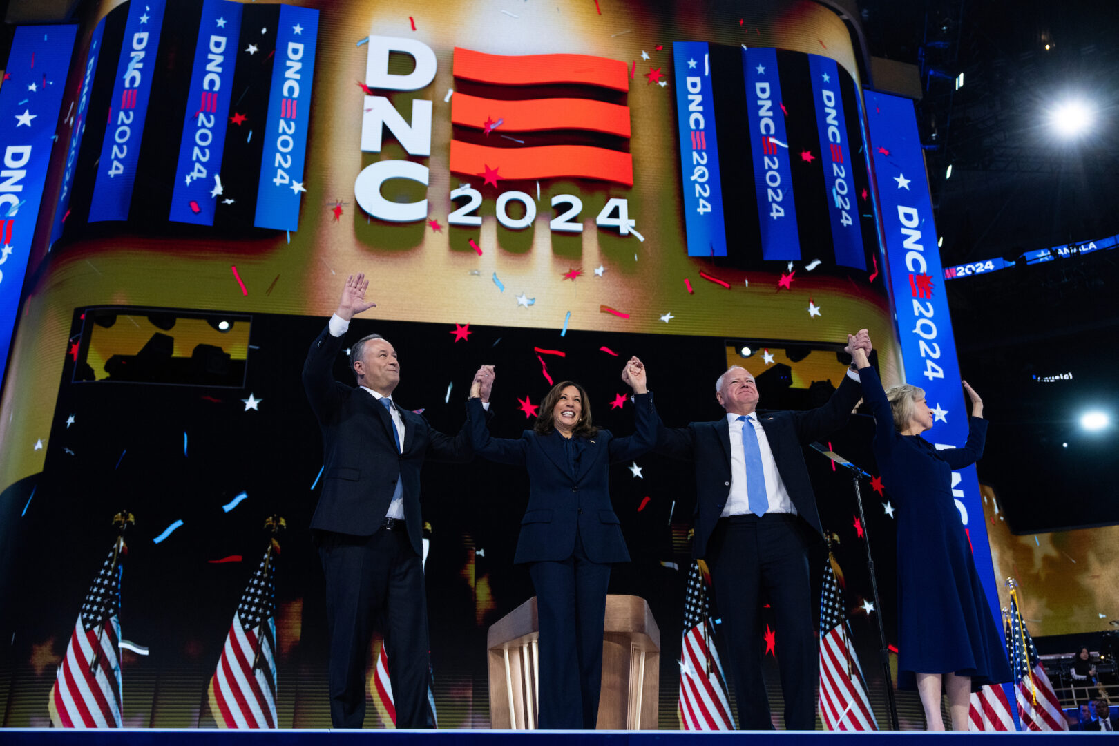 Democratic presidential nominee and Vice President Kamala Harris and her running mate, Minnesota Gov. Tim Walz, celebrate with their spouses on the final night of the Democratic National Convention in Chicago on Aug. 22, 2024. (Tom Williams/CQ Roll Call)