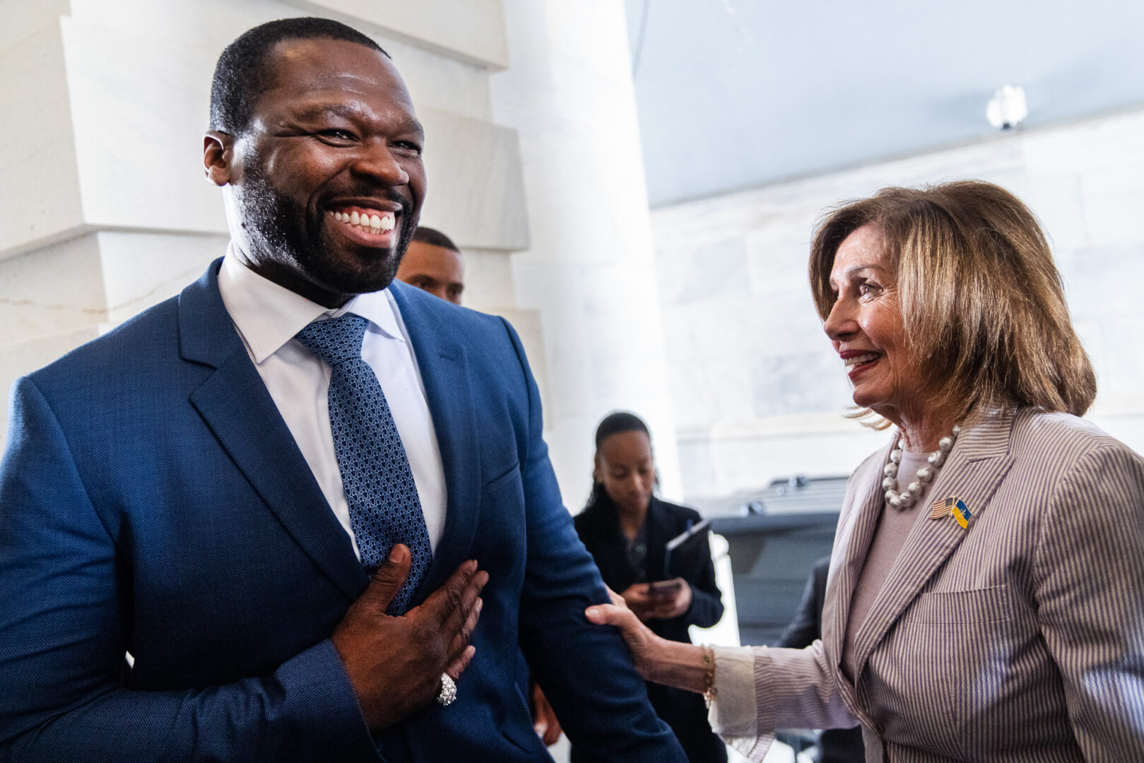 Rapper and businessman Curtis “50 Cent” Jackson is greeted by former Speaker Nancy Pelosi at the Capitol on Wednesday after Jackson and attorney Ben Crump met with congressional leaders about increasing minority representation in the multibillion-dollar luxury spirits industry.