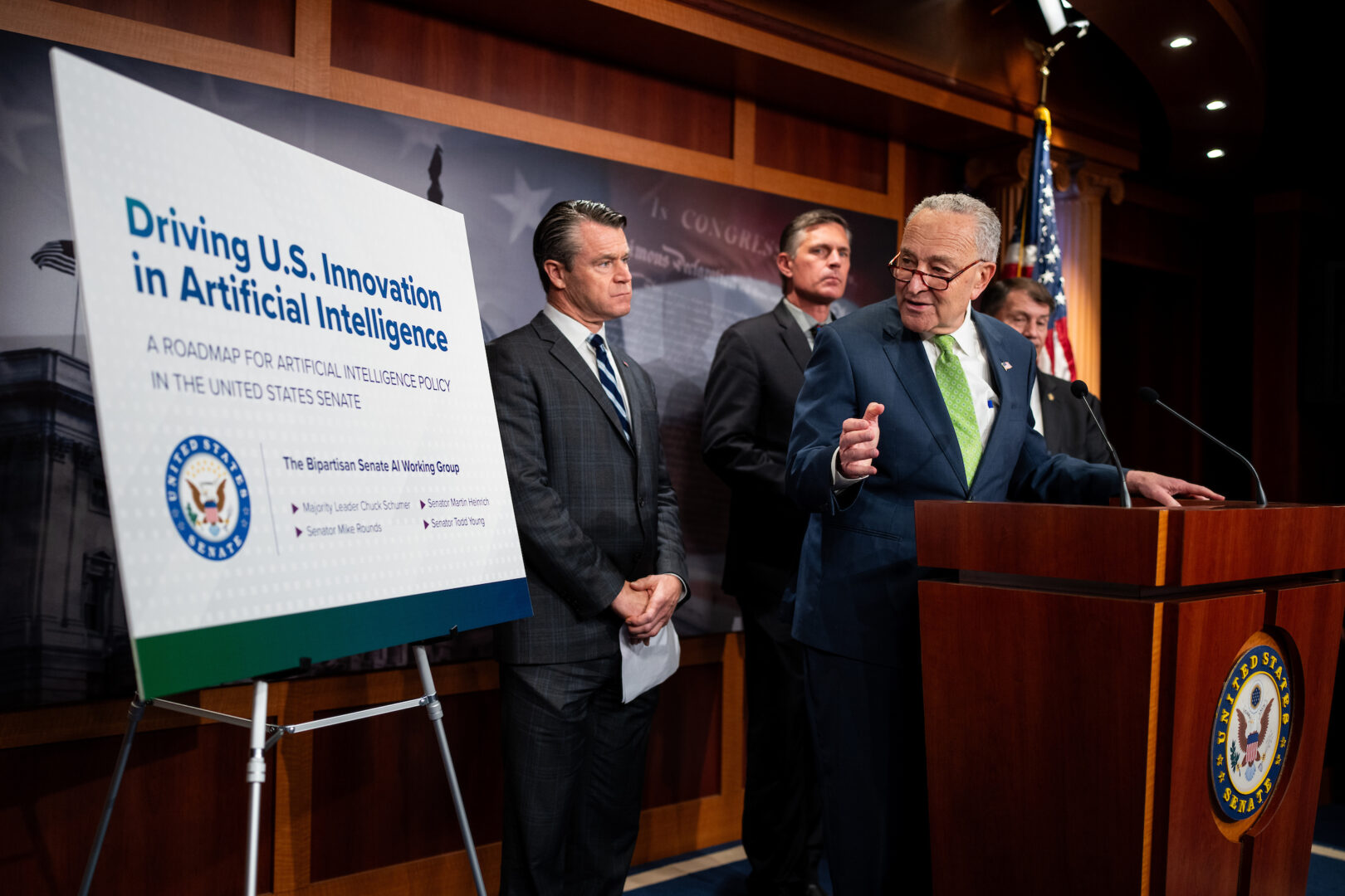 Senate Majority Leader Charles E. Schumer with, from left, Sens. Todd Young, Martin Heinrich and Mike Rounds, holds a news conference on their AI road map on May 15.