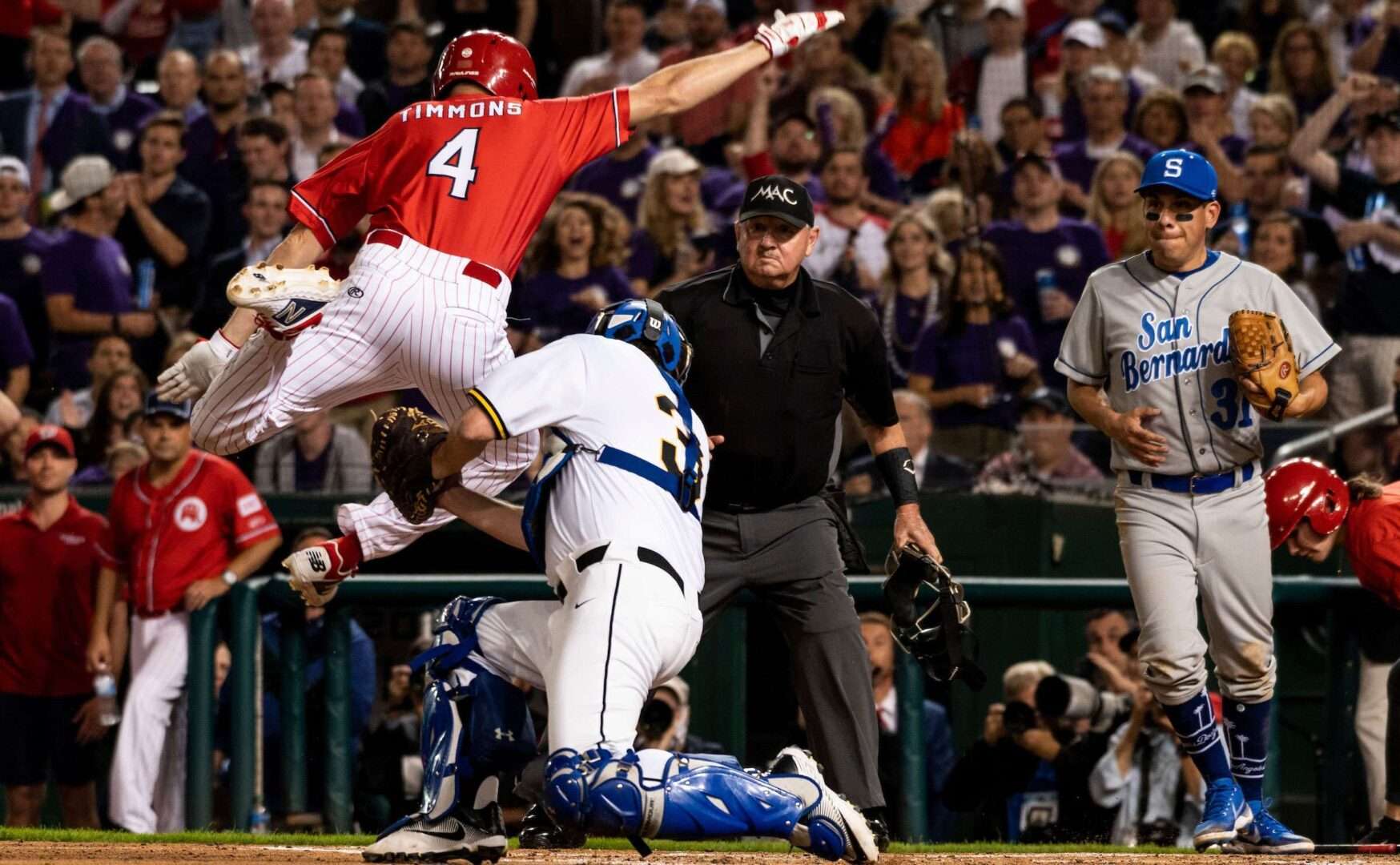 Republican runner Rep. William R. Timmons IV of South Carolina is tagged out at home plate by Democratic catcher Sen. Christopher S. Murphy of Connecticut during the 2021 Congressional Baseball Game at Nationals Park.