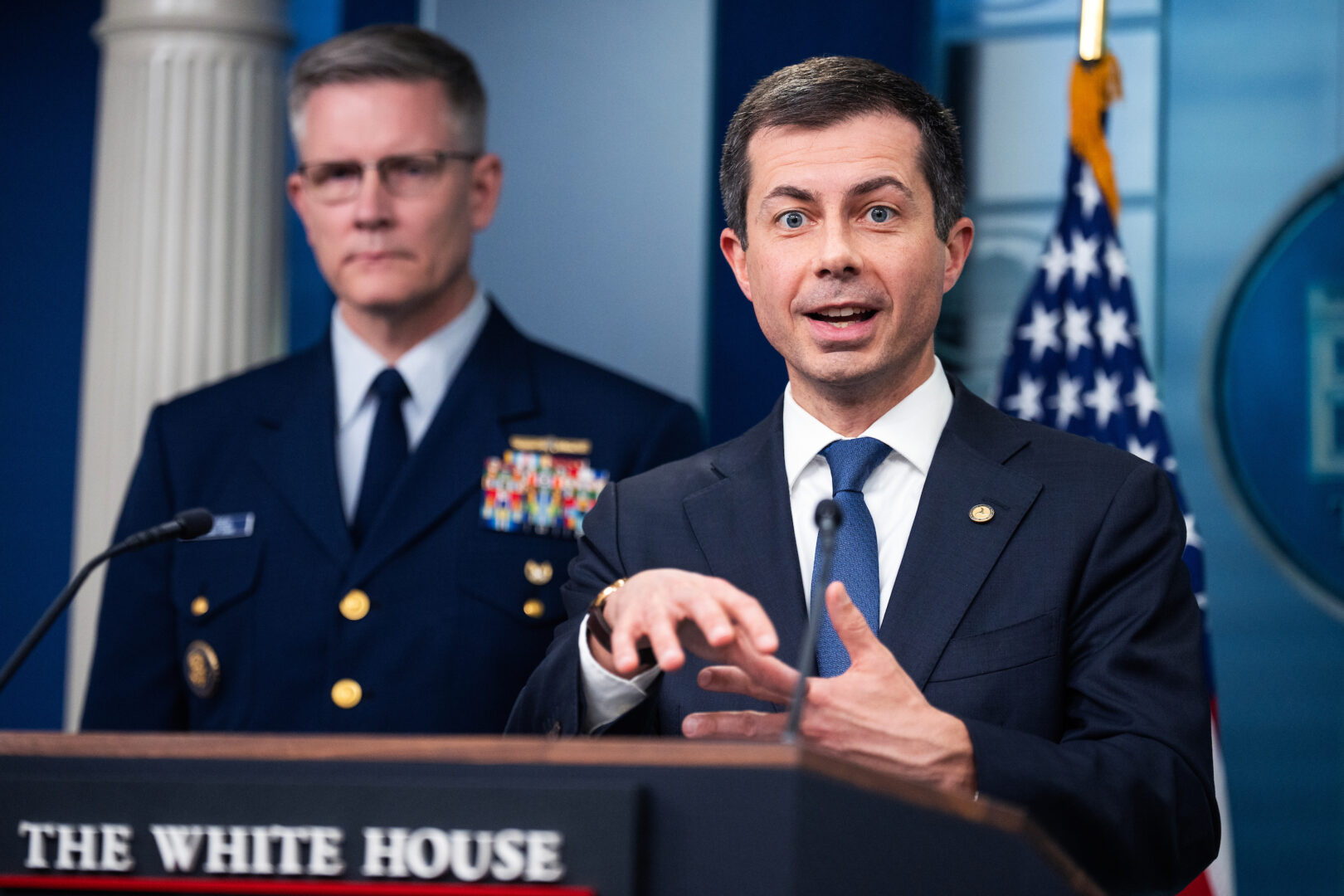 Transportation Secretary Pete Buttigieg speaks about Tuesday’s collapse of the Francis Scott Key Bridge in Baltimore during a White House press briefing Wednesday. Vice Admiral Peter W. Gautier, Coast Guard deputy commandant for operations, is standing behind him.