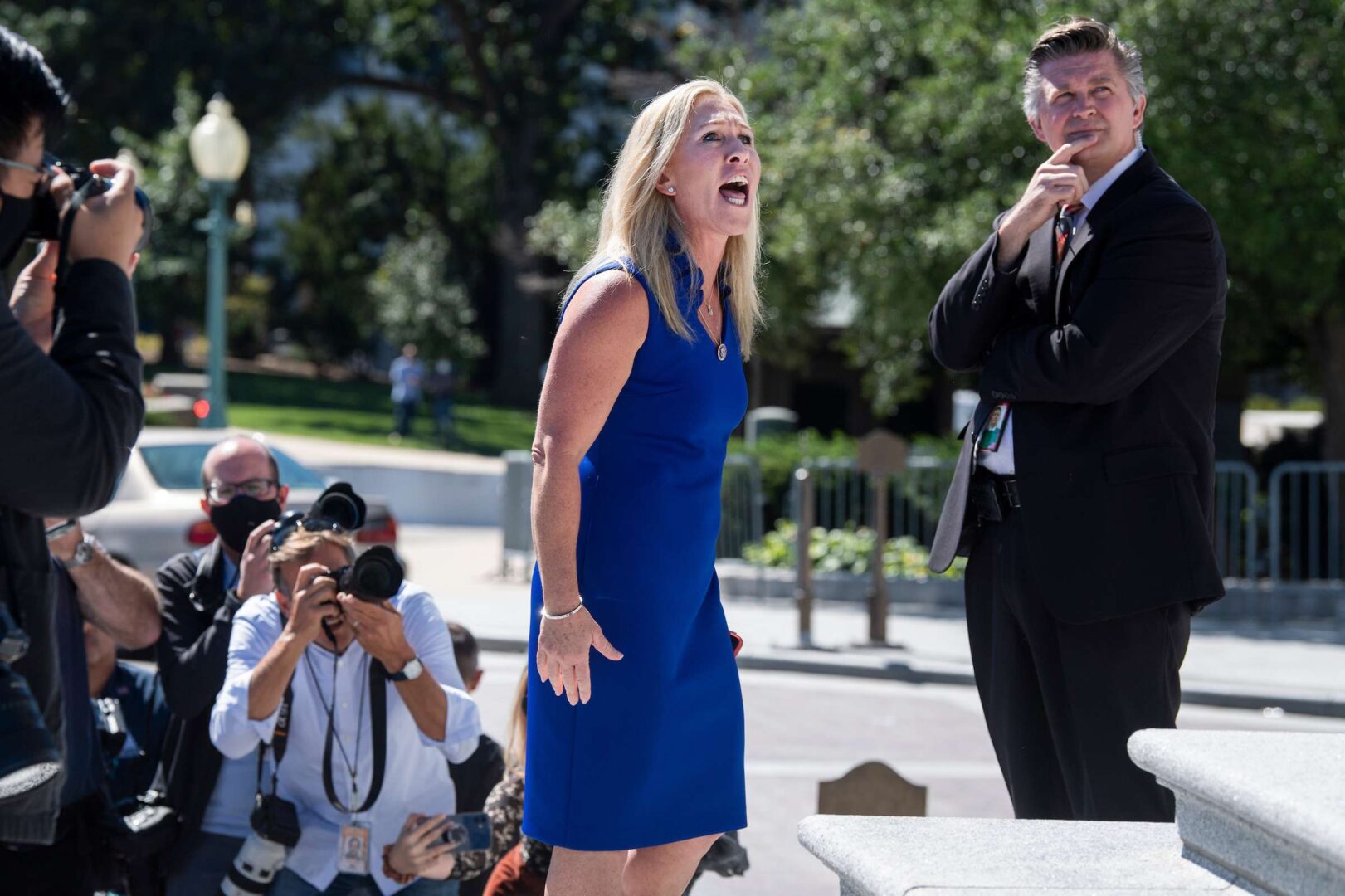 Rep. Marjorie Taylor Greene, R-Ga., argues with Rep. Debbie Dingell, D-Mich., off camera, during a "Build Back Better for Women" rally held by Democrats on the House steps in September.