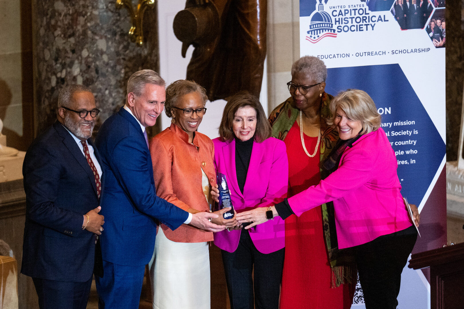 Former House Clerk Cheryl Johnson, center, receives the Freedom Award on Tuesday. She is joined on stage by, from left, Rep. Troy Carter, former Speaker Kevin McCarthy, Speaker Emerita Nancy Pelosi, former House Clerk Lorraine Miller, and Capitol Historical Society President Jane Campbell.