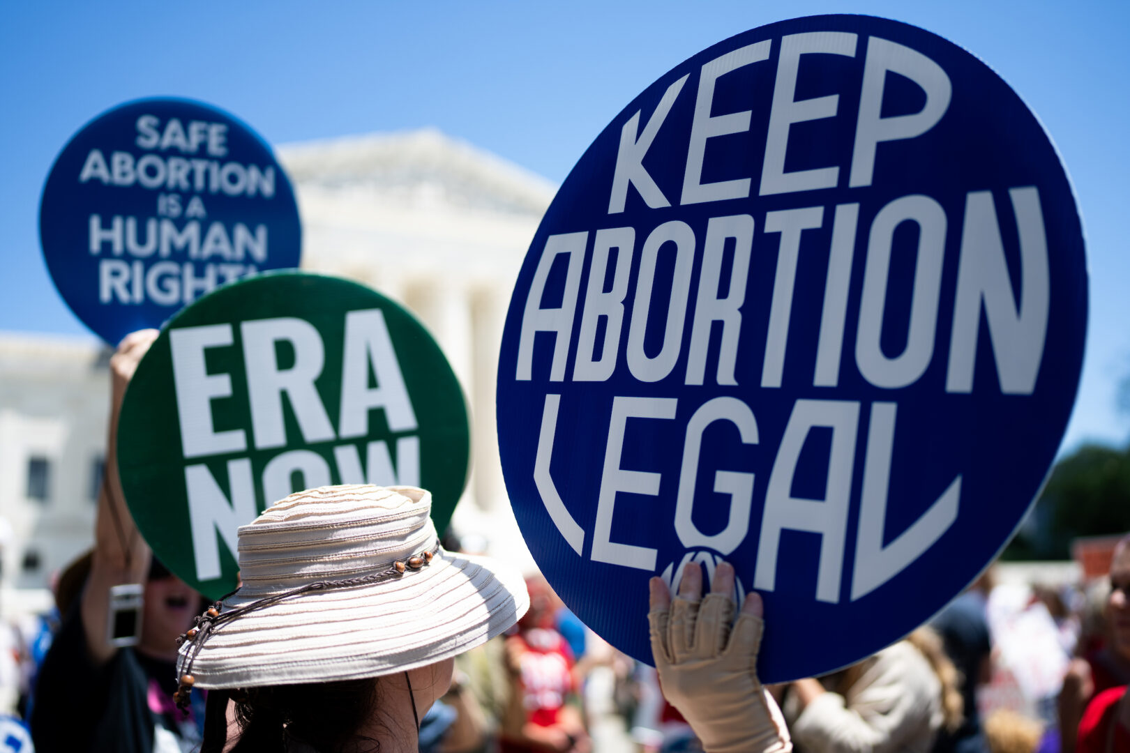 Protesters hold signs outside the Supreme Court on June 24 to mark the second anniversary of the reversal of Roe v. Wade. In a new book, journalist Amanda Becker  chronicles the upheaval and activism that followed the decision.