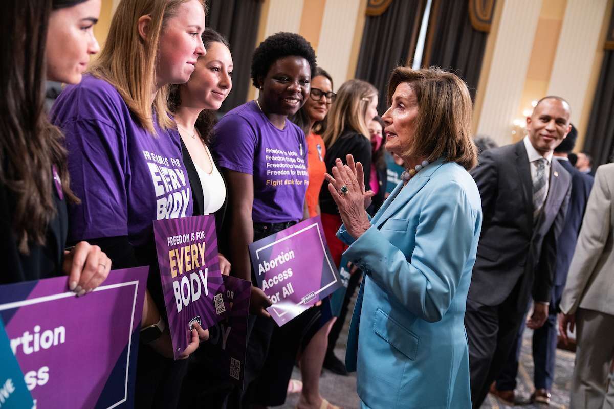 Rep. Nancy Pelosi, D-Calif., talks with guests during a Pro-Choice Caucus event in the Cannon Building’s Speaker Nancy Pelosi Caucus Room marking one year since the Dobbs v. Jackson Women’s Health Organization decision on Friday, June 23, 2023. The Supreme Court’s decision in Dobbs overturned the national right to abortion on June 24, 2022. House Minority Leader Hakeem Jeffries, D-N.Y., appears at right.