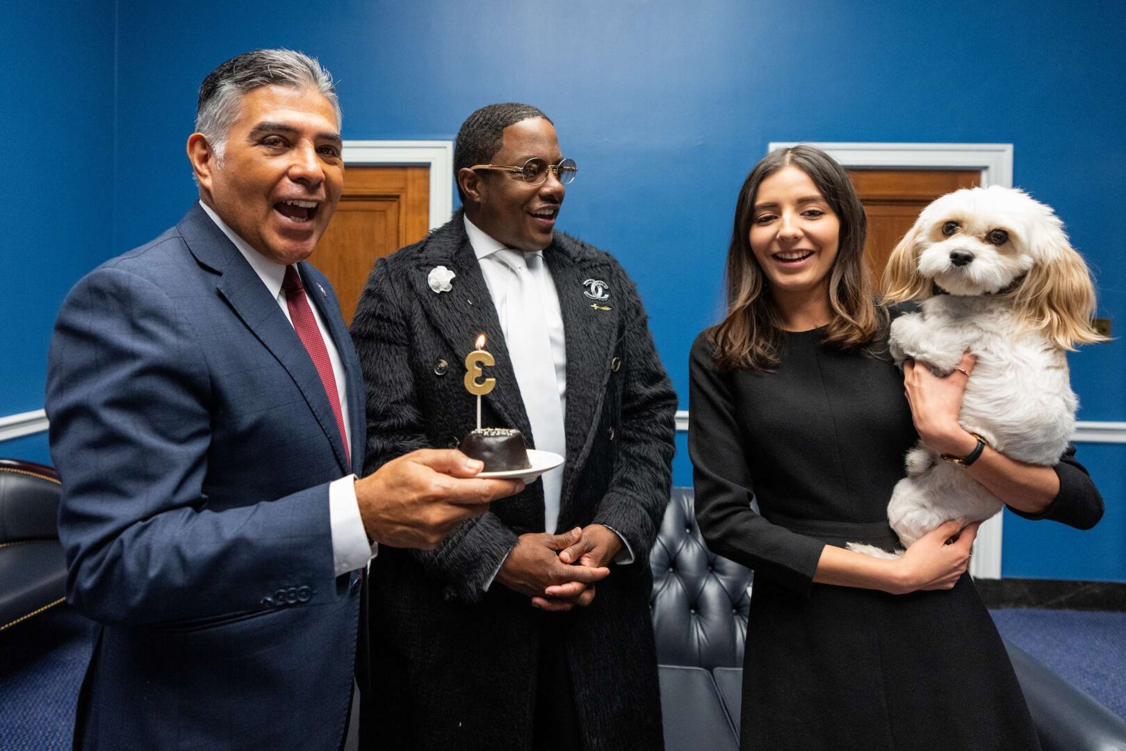 Cavapoo mix Teddy, held by owner and staffer Clarissa Rojas, celebrates his birthday in the Rayburn House Office Building on on Sept. 30. He gets a little help from Rep. Tony Cárdenas, left, and rapper Mase.