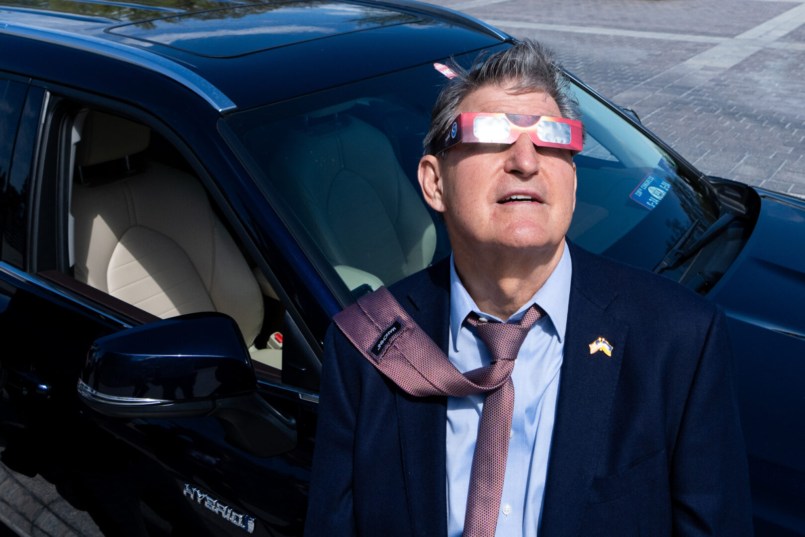 Sen. Joe Manchin III, D-W.Va., gathered outside the Capitol along with tourists and staffers on Monday to view the solar eclipse. (Bill Clark/CQ Roll Call)