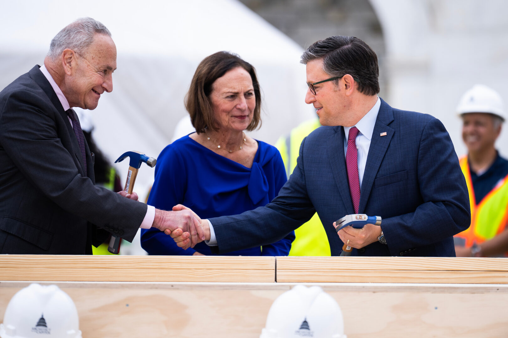 Senate Majority Leader Charles E. Schumer, Sen. Deb Fischer and Speaker Mike Johnson take part in a Wednesday ceremony marking the start of inaugural platform construction at the Capitol.