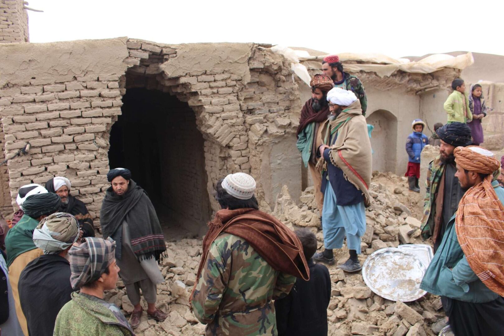 People are seen on debris of a damaged house after the earthquake in Qala-e-Naw district of Badghis, Afghanistan on Jan. 18.