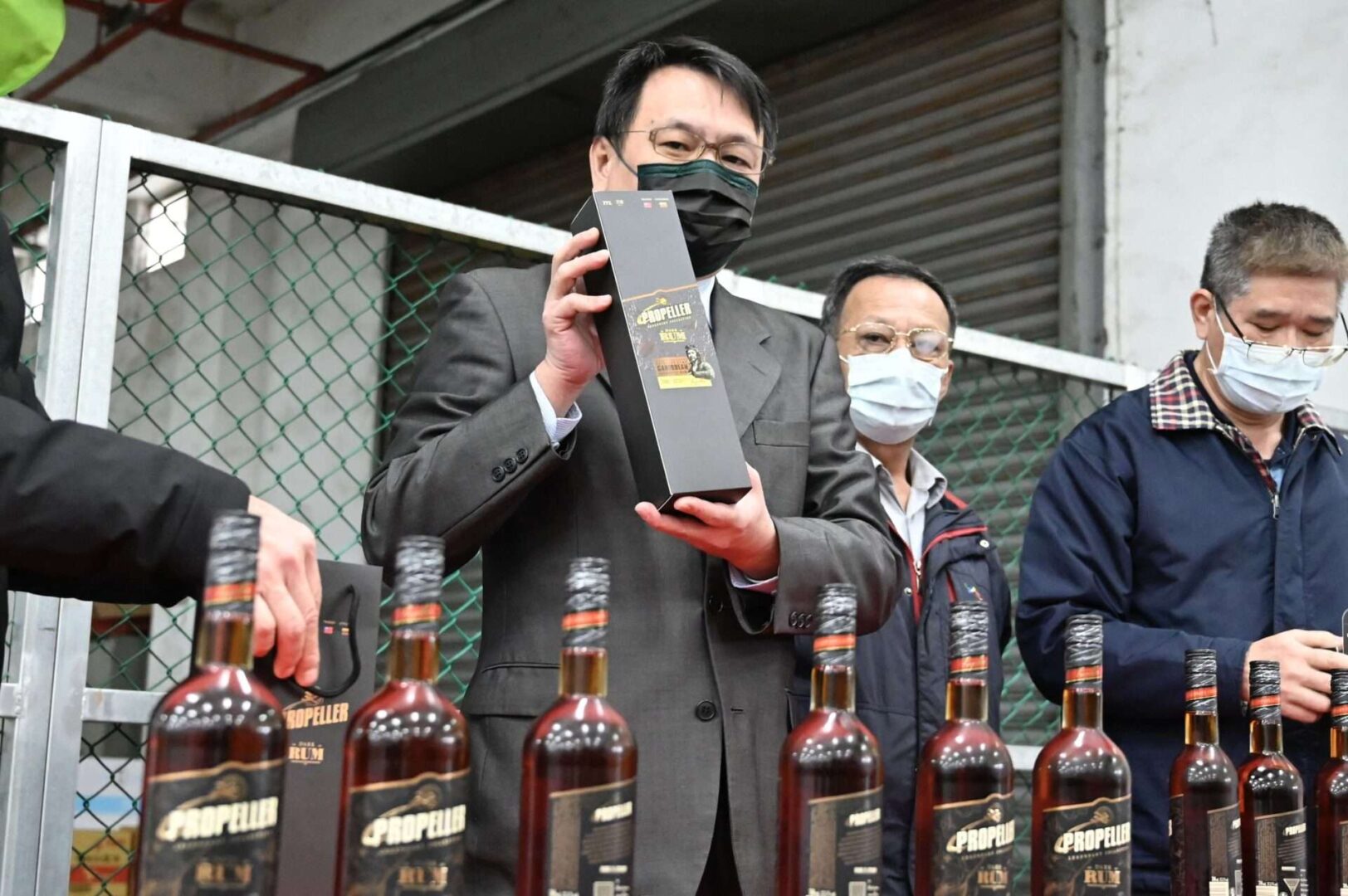 Ting Yen-che, chairman of Taiwan Tobacco and Liquor Corporation, poses with bottles of rum imported from Lithuania in Taoyuan on Jan. 22, after the state-run liquor company snapped up 20,000 bottles of the spirit blocked from China after a row between Beijing and Vilnius. 