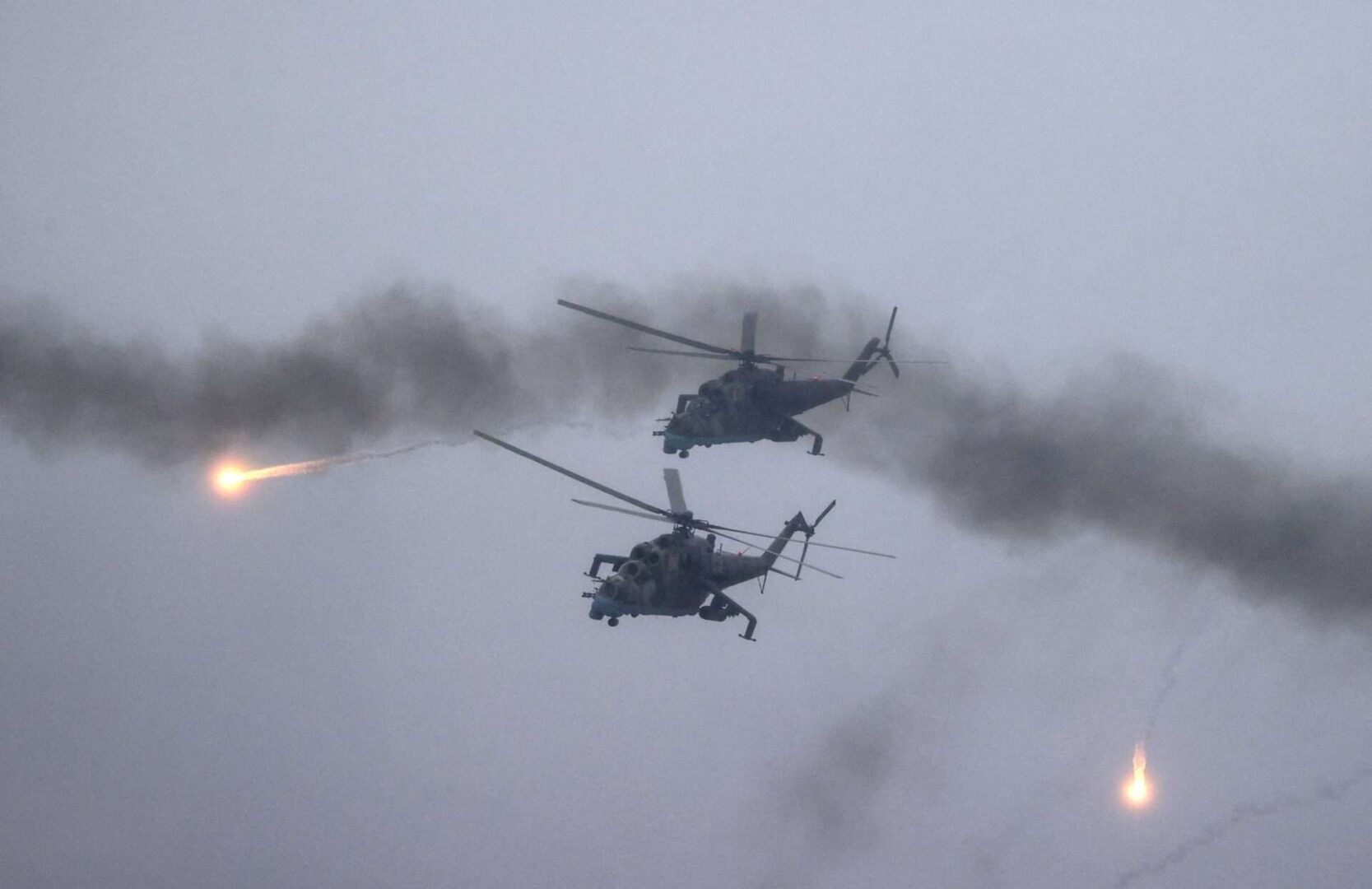 Belarusian Air Force Mi-24 helicopters fire during joint exercises with Russia as the Kremlin continues massing forces along its border with Ukraine. 