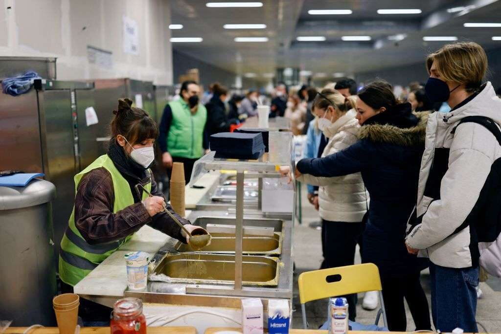 A volunteer distributes food to Ukrainian refugees upon their arrival at the main railway station in Berlin on Monday.