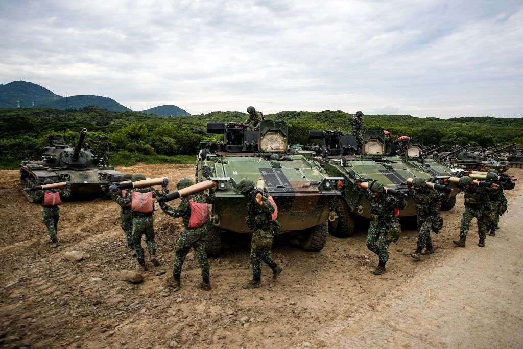 Taiwanese soldiers carrying artillery to tanks during recent live-fire drills.