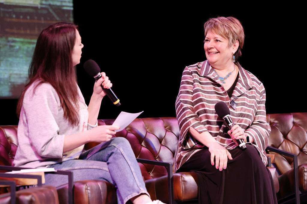 Erin Ryan, left, interviews Judge Janet Protasiewicz, a candidate in Wisconsin's upcoming state Supreme Court race, during the live recording of "Pod Save America"on March 18 in Madison, Wis. 