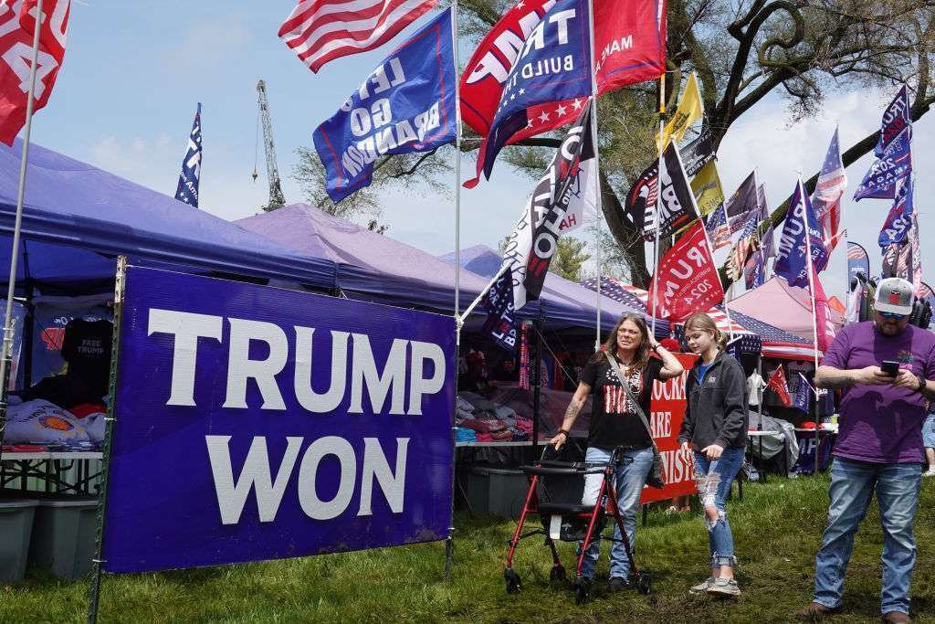 Guests walk past vendors as they arrive for what was supposed to be a rally hosted by former President Donald Trump on May 13 in Des Moines, Iowa. Trump's campaign canceled the rally before the gates were officially opened due to the possibility of tornadoes moving through the region.  