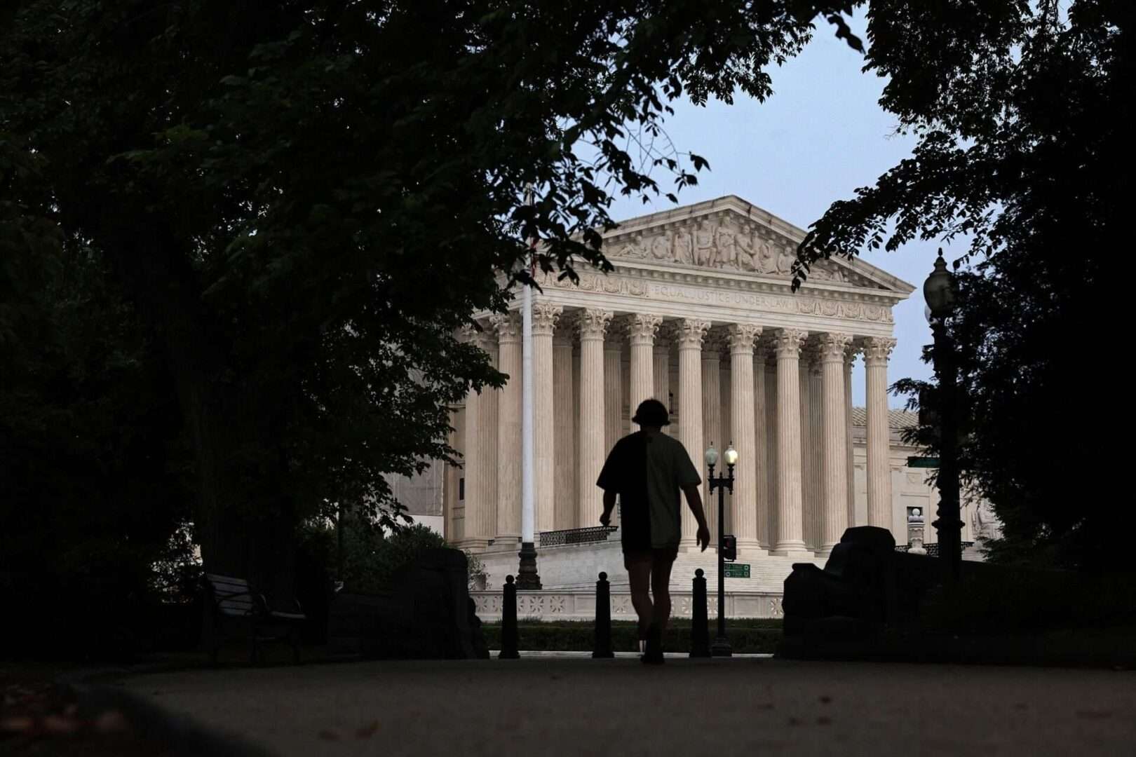 A pedestrian is seen near the U.S. Supreme Court on June 5. The court on Thursday ruled 7-2 to protect the right of Medicaid nursing home residents to seek relief in federal court when state officials do not meet a certain quality of care.