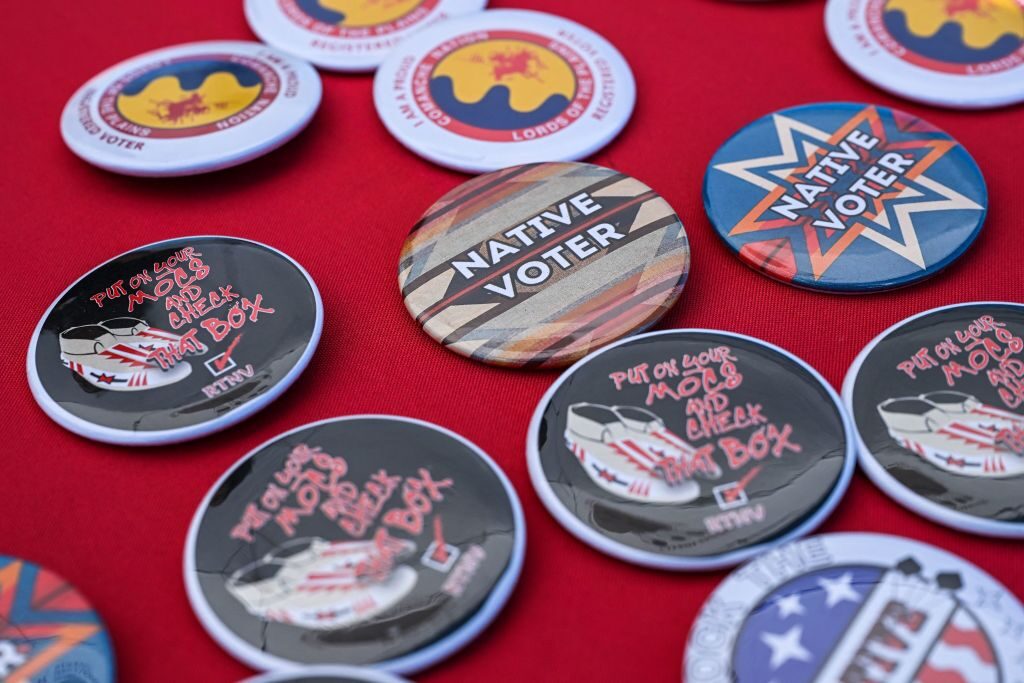 Pins to promote voting by Native Americans are at a display counter during a cultural meeting at the Comanche Nation fairgrounds in Lawton, Okla., on Sept. 30, 2023. 