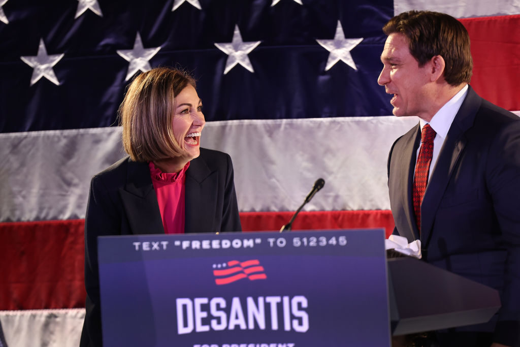 Republican presidential candidate and Florida Gov. Ron DeSantis speaks with Iowa Gov. Kim Reynolds during a campaign rally on Nov. 6 in Des Moines, Iowa. Reynolds endorsed DeSantis' run for president at the event.