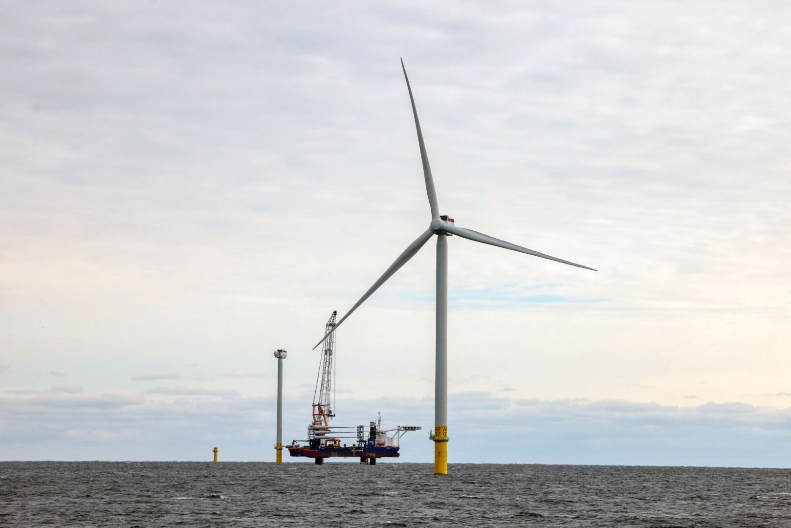 A wind turbine, along with two under construction behind it, at the South Fork Wind Farm off the coast of Long Island, N.Y., in December.