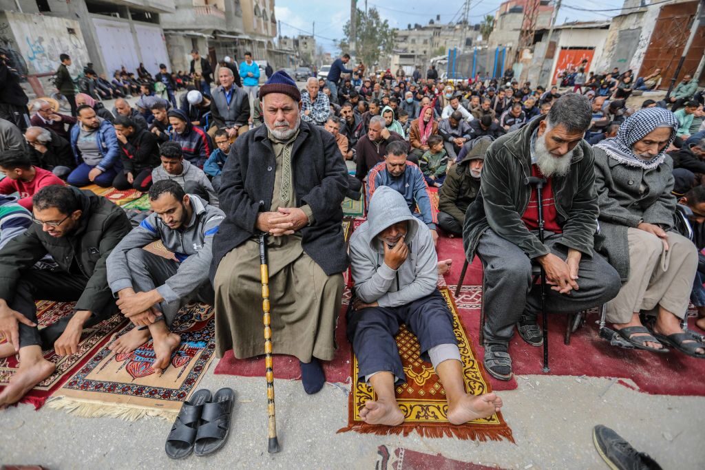 Palestinians pray on March 22 in the Rafah area of Gaza during the second Friday prayer of the holy month of Ramadan on the ruins of Al-Farouq Mosque, which was destroyed by Israeli airstrikes.