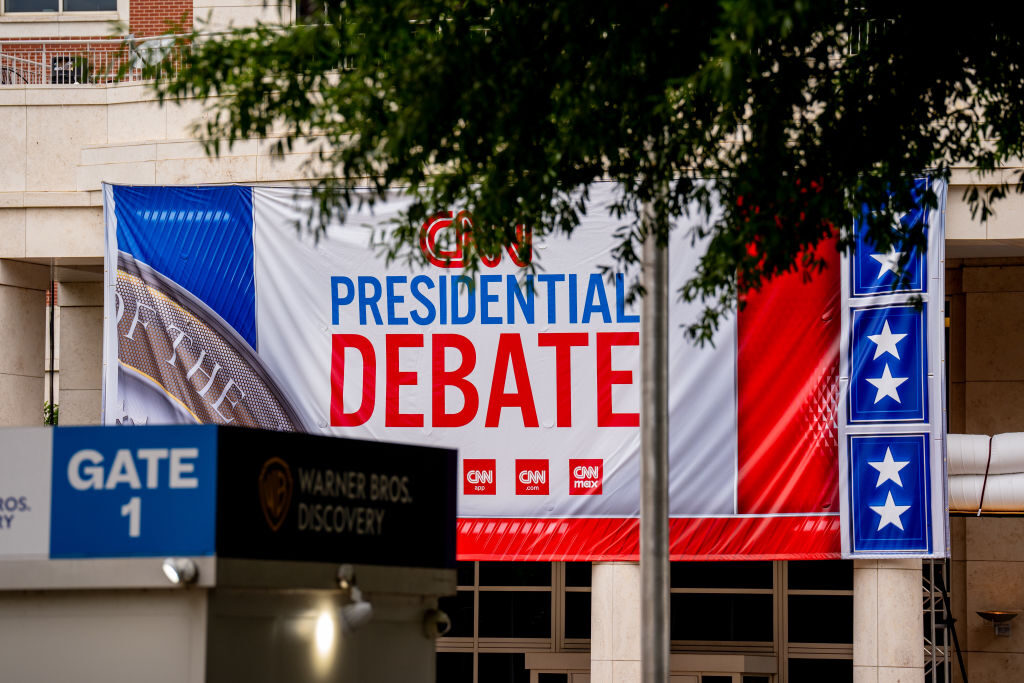 Signage for Thursday's presidential debate is seen as workers set up security fencing outside CNN's studios at the Turner Entertainment Networks in Atlanta.