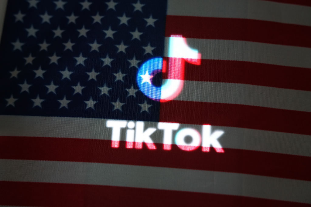 An American flag and the TikTok logo. 