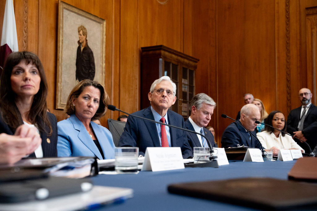 Attorney General Merrick B. Garland, center, takes a question Wednesday from a reporter during an Election Threats Task Force meeting at the Justice Department in Washington. Garland also announced two actions against Russia for attempted covert influence operations. 