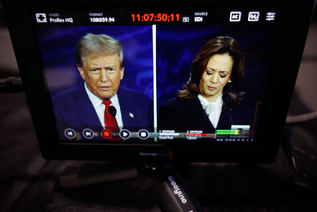 Former President Donald Trump, the Republican nominee for president, and  Vice President Kamala Harris, the Democrats' presidential nominee, are seen on a screen as they debate for the first time Tuesday night in Philadelphia. 