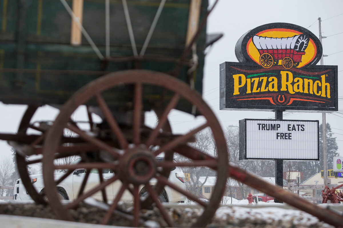 A Pizza Ranch sign advertises "Trump Eats Free" after Republican presidential candidate Donald Trump visited the John Wayne Museum, Jan. 19, 2016, in Winterset, Iowa.