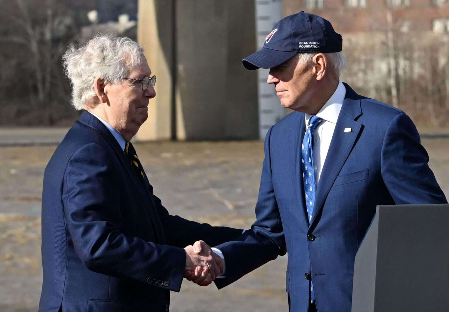 President Joe Biden shakes hands with Senate Minority Leader Mitch McConnell during an event Wednesday to tout the bipartisan infrastructure law in front of the Brent Spence Bridge in Covington, Ky.