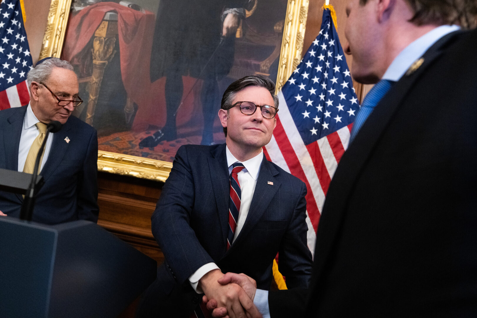 Senate Majority Leader Charles E. Schumer, at left, and Speaker Mike Johnson, center, are trying to pass a short-term funding patch this week to head off a partial shutdown.