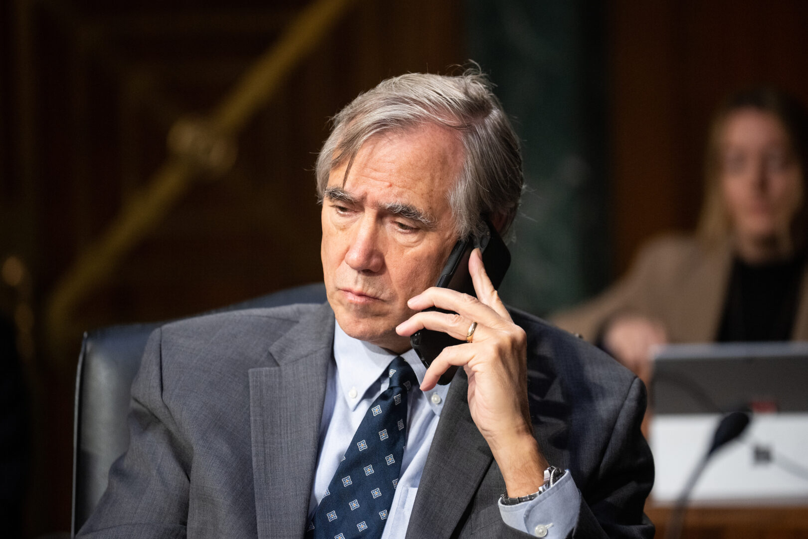 Sen. Jeff Merkley, D-Ore., talks on his phone before a Senate Appropriations Committee hearing on Oct. 31, 2023. 