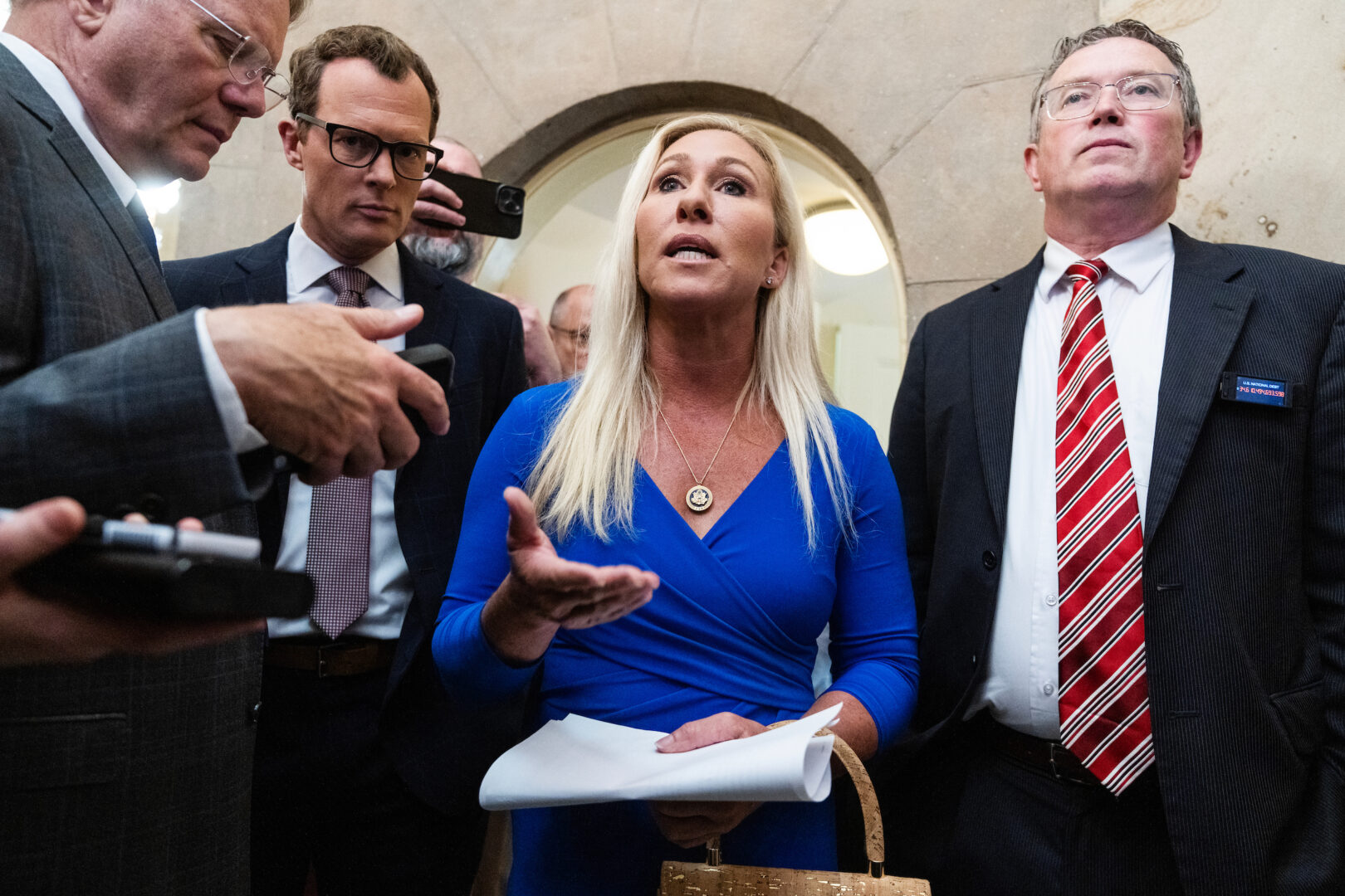 Reps. Marjorie Taylor Greene, R-Ga., and Thomas Massie, R-Ky., talk with reporters before a meeting with Speaker Mike Johnson, R-La., in the Capitol on Tuesday.  