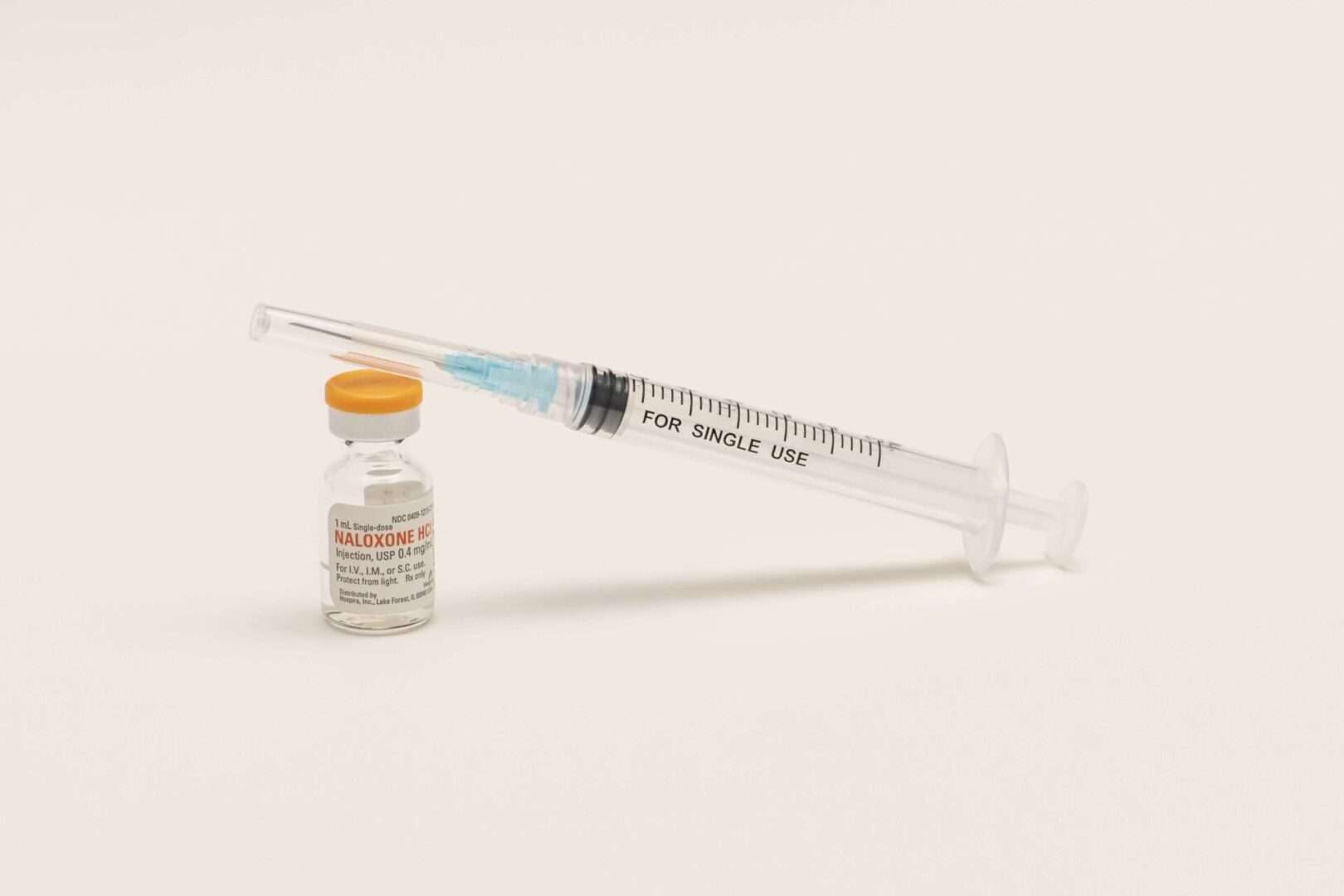 A bottle of naloxone  with a needle. Naloxone nasal sprays, which are used to counter opioid overdoses, appear headed for over-the-counter use after an FDA advisory committee's recommendation.