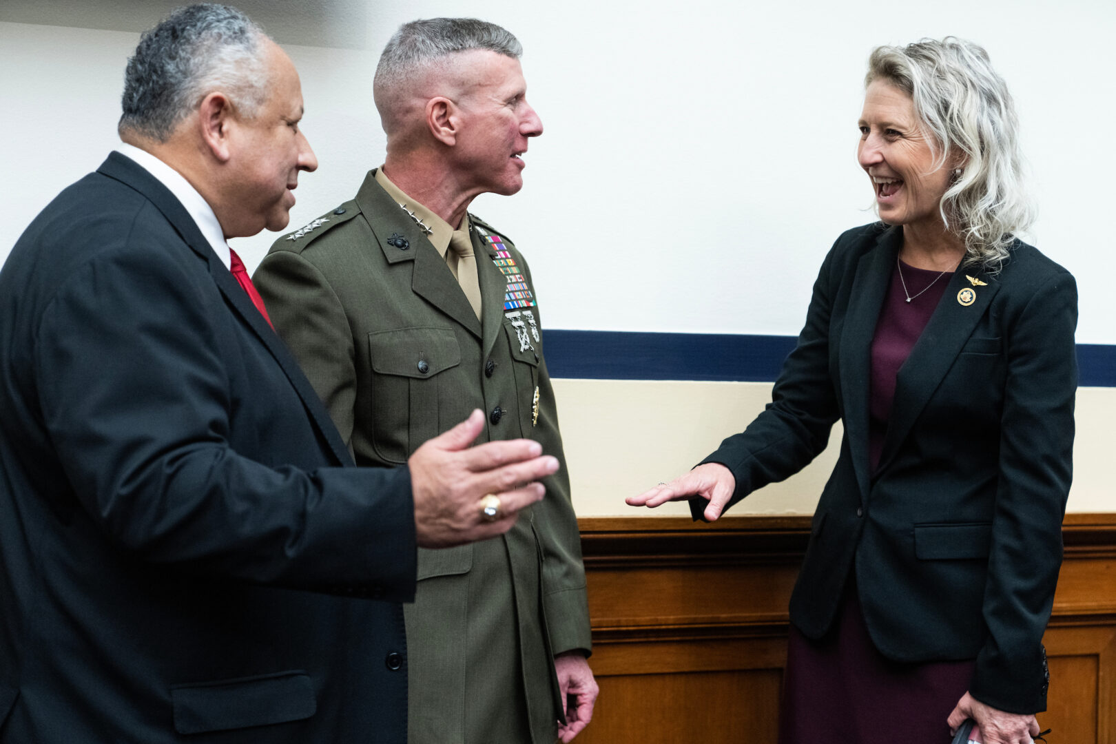 Rep. Jen Kiggans, R-Va., talks with Gen. Eric M. Smith, commandant of the U.S. Marine Corps, and Secretary of the Navy Carlos Del Toro, left, during a House Armed Services Committee hearing on the Navy budget request, on May 1. 