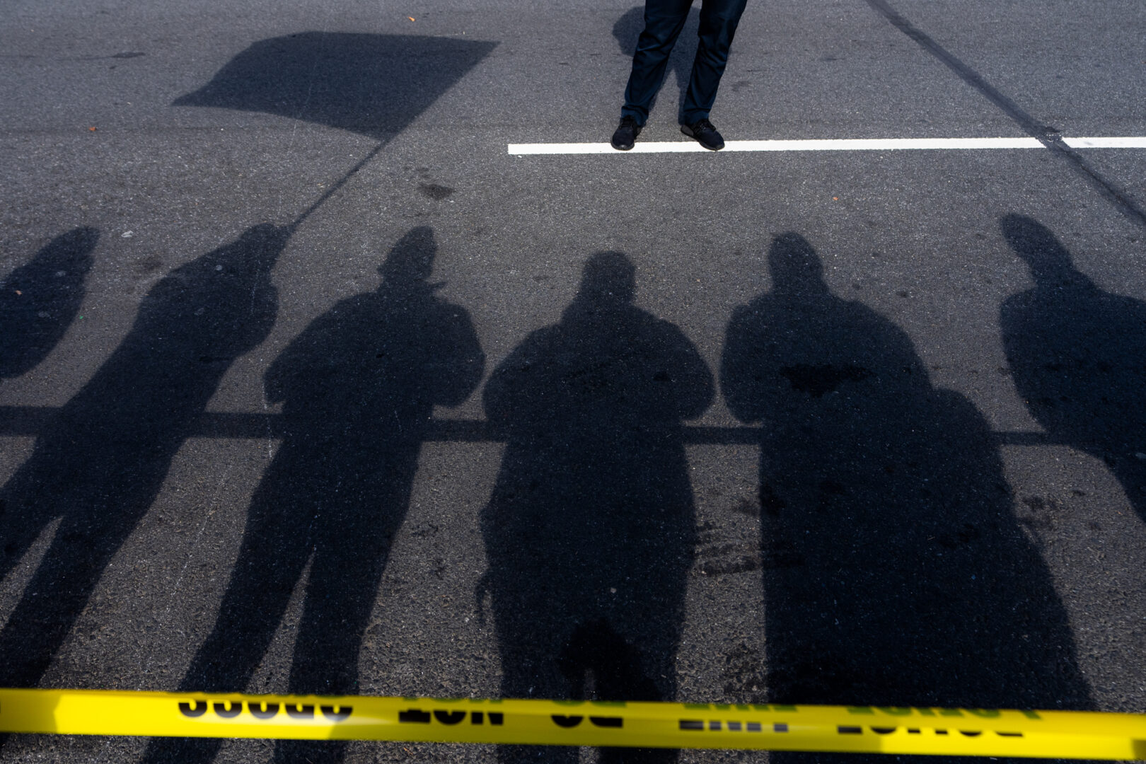 Spectators look on as a D.C. Metropolitan Police officer stands guard on Constitution Avenue Northwest during the first National Veterans Parade in Washington on Sunday. (Bill Clark/CQ Roll Call)