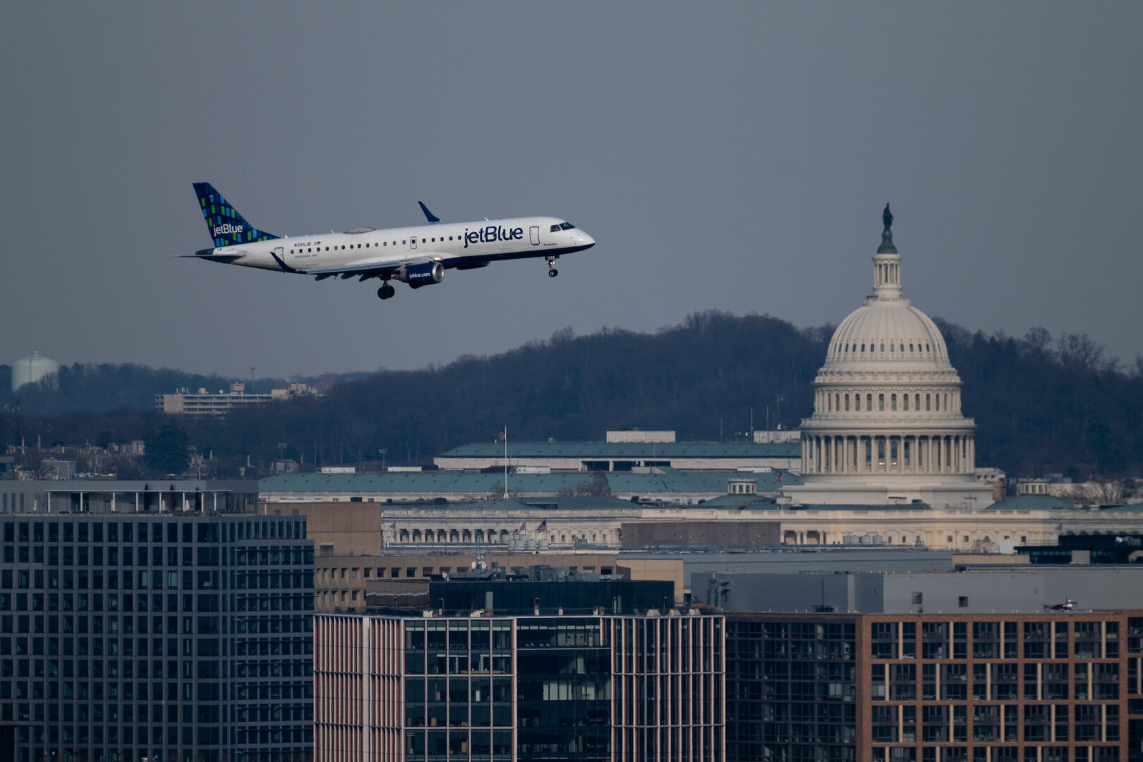 An JetBlue Embraer ERJ-190 plane flies past the Capitol dome as it comes in for a landing at Ronald Reagan Washington National Airport on Friday. 