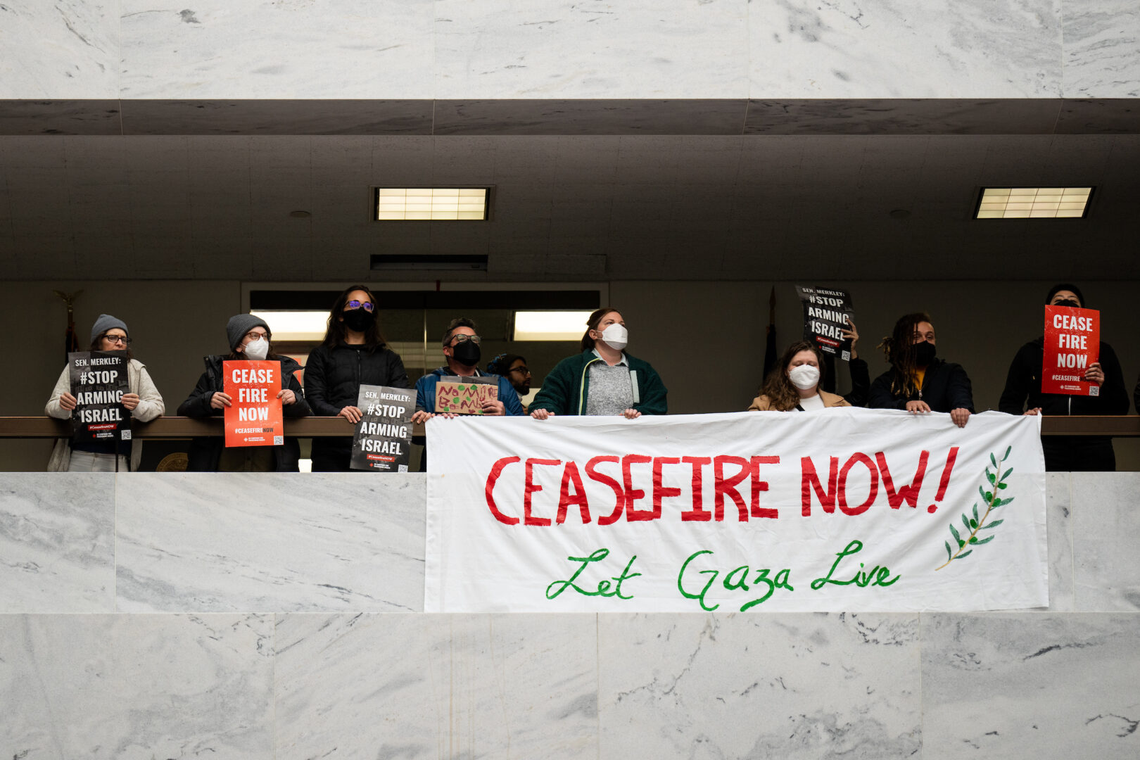 Anti-war protesters hold banners and signs calling for a cease-fire in Gaza on Nov. 3 in the Hart Senate Office Building.