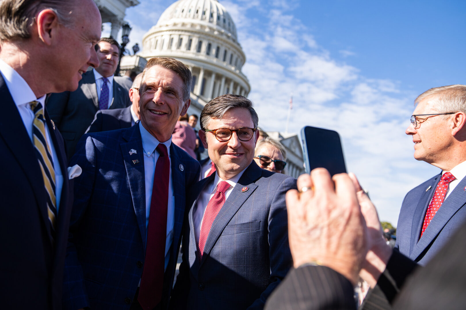 Newly elected Speaker Mike Johnson, second from right, takes photos with members after a news conference on the House steps of the Capitol after winning the speakership on Wednesday.