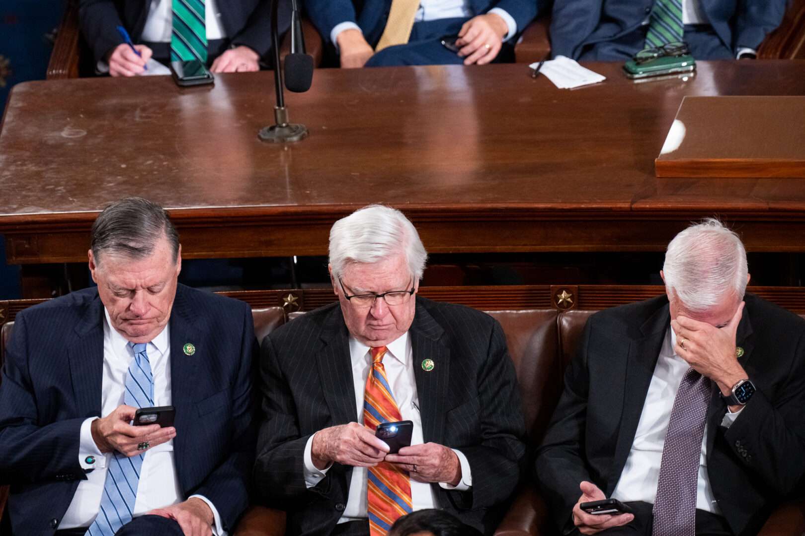 From left, Reps. Tom Cole, R-Okla., Hal Rogers, R-Ky., and Steve Womack, R-Ark., look at their phones on the House floor during Friday's third unsuccessful vote to elect a new speaker.