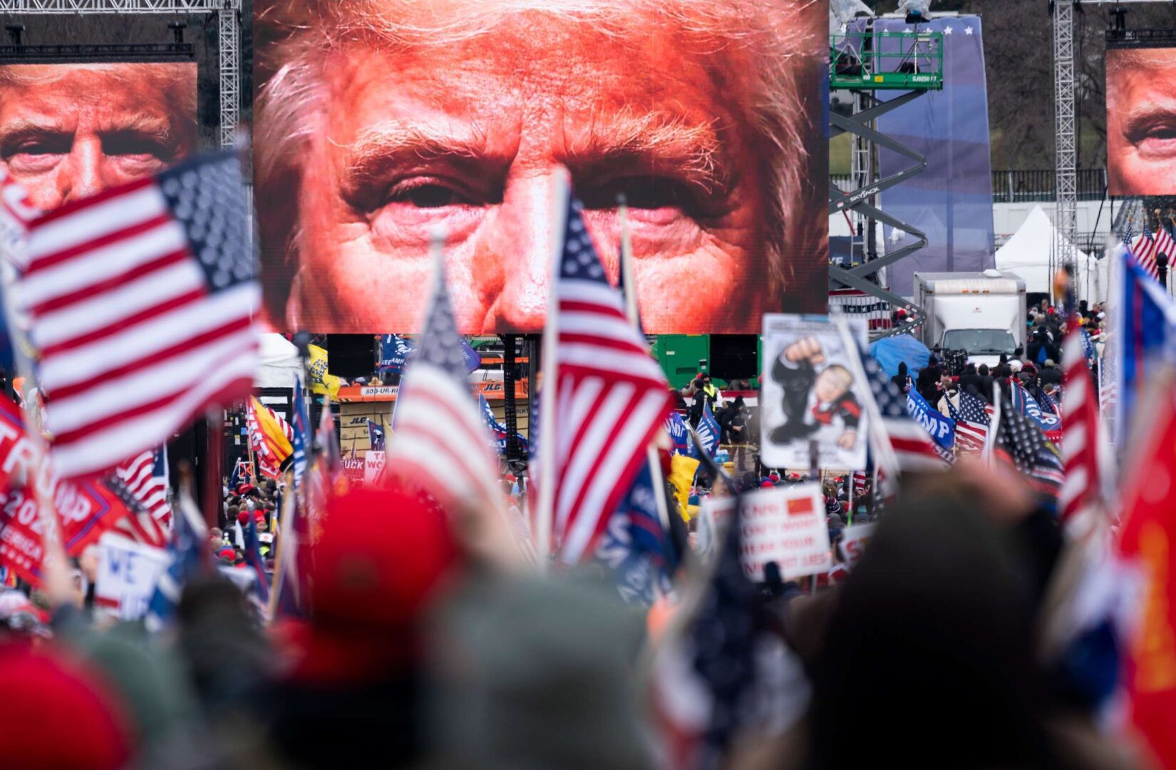 An image of President Donald Trump appears on video screens before his speech to supporters on Jan. 6, 2021, as Congress prepared to certify the Electoral College votes.