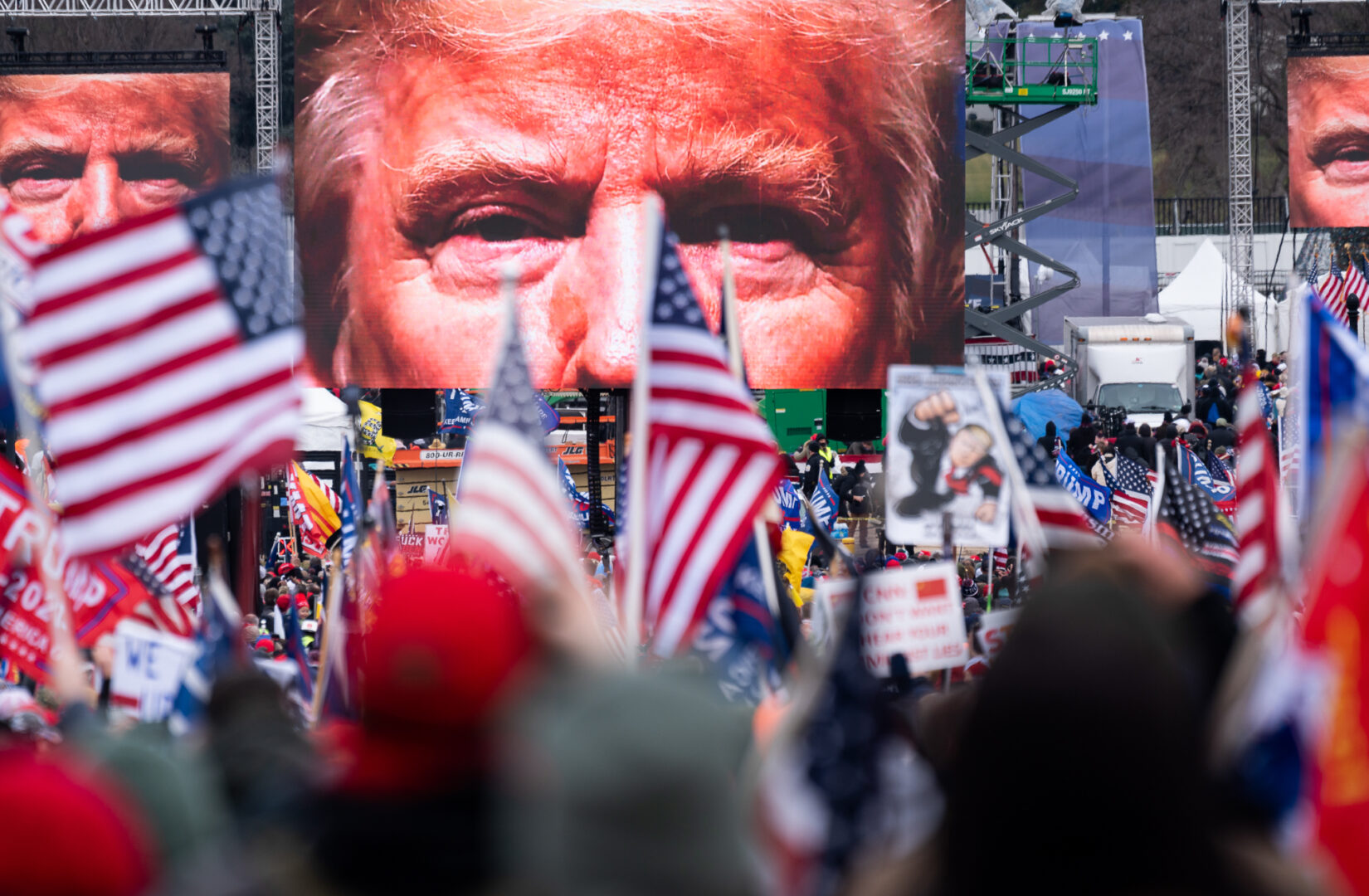 10:57AM: An image of President Donald Trump appears on video screens "stop the steal" rally at the Ellipse outside of the White House in Washington on January 6, 2021, as the Congress prepares to certify the electoral college votes.