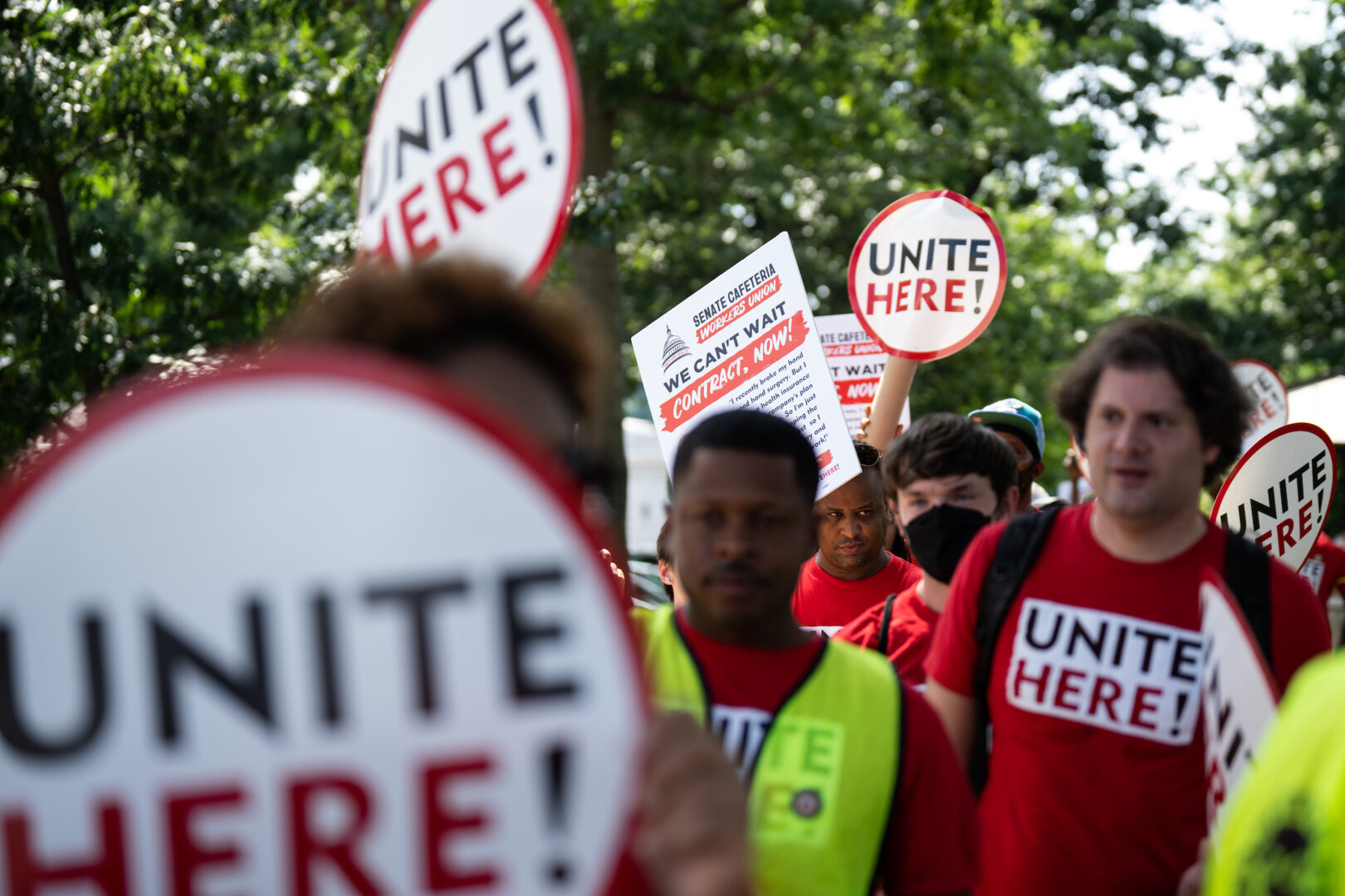 House dining workers are looking to the future after finalizing a new collective bargaining agreement with Sodexo. Above, Unite Here union members hold signs near the Capitol in support of Senate cafeteria workers on July 20, 2022.