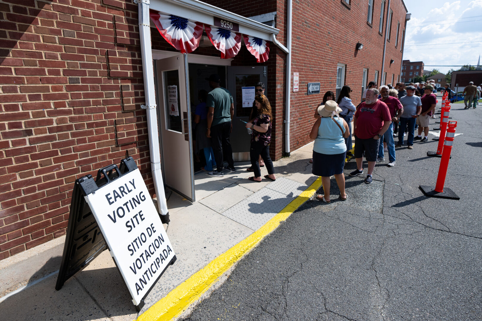 Voters at the Prince William County Office of Elections in Manassas, Va., stand in line on Friday to cast their ballots on the first day of early voting in the state.