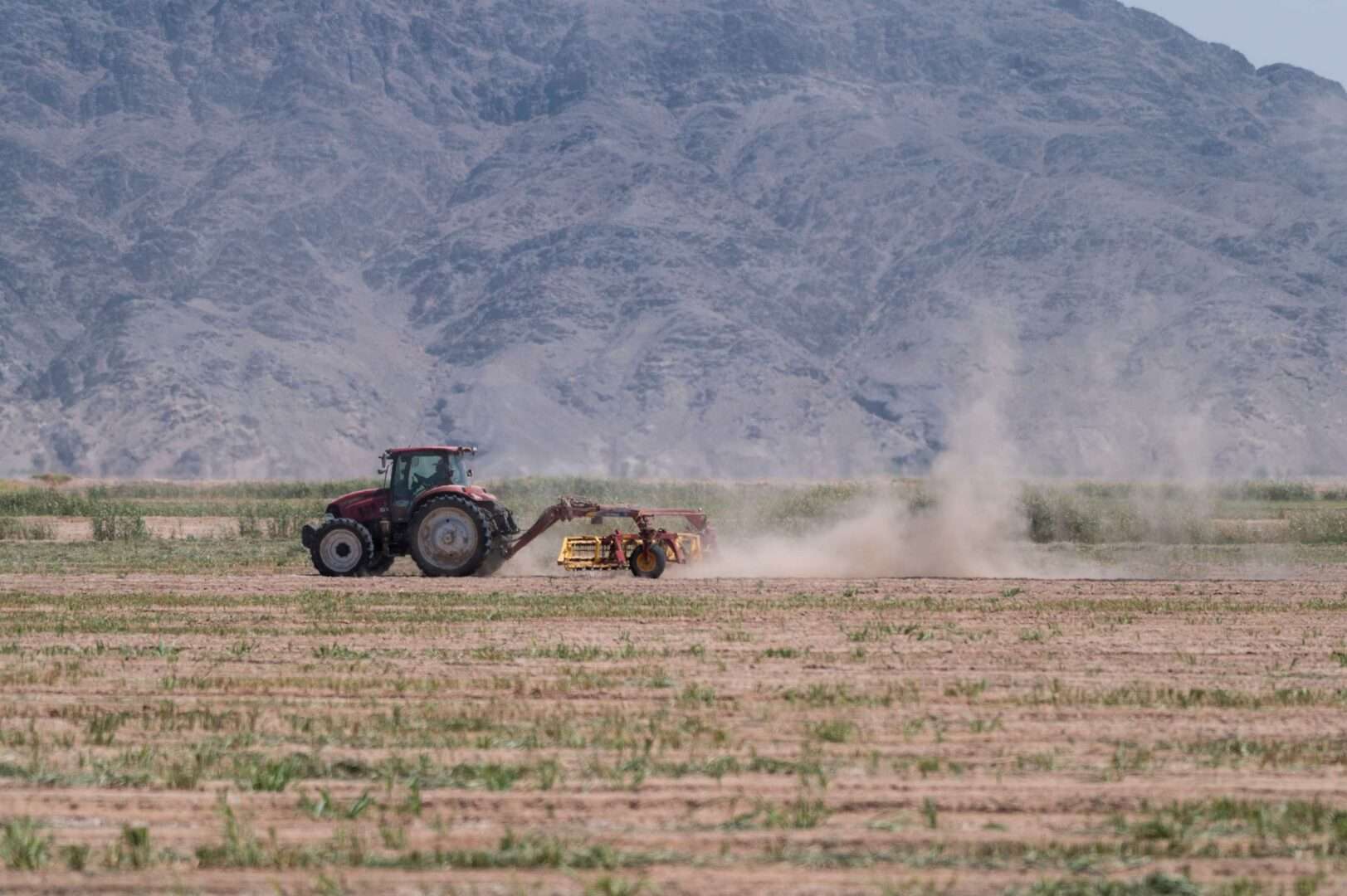 A tractor kicks up dust as it works a field near Parker, Ariz. Farms in the area rely on water drawn from the Colorado River. 